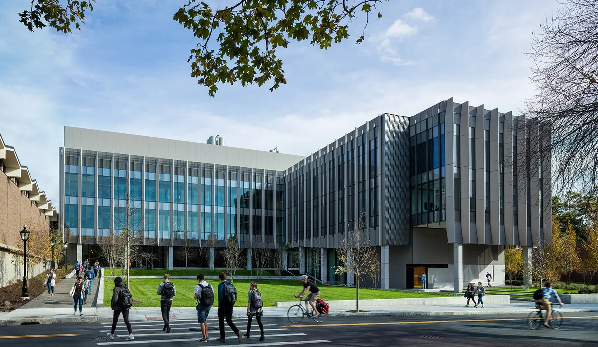 Students walking and cycling outside Brown University’s Engineering Research Center